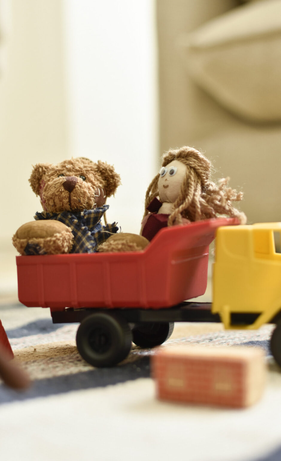 Bonecos em caminhão de brinquedo com pecinhas de jogos em volta.